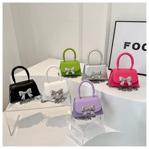 Chic mini crossbody bags in various colors with metallic bow accent and chain straps