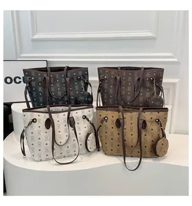 Detail of four patterned tote bags in brown and beige with matching coin purse charms
