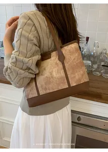 Detail of vintage tote bag with marble texture fabric and premium brown leather trim