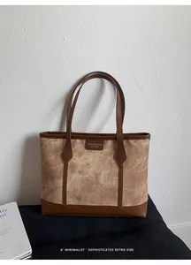 Detailed view of the woven fabric texture and brown leather patch on the tote bag
