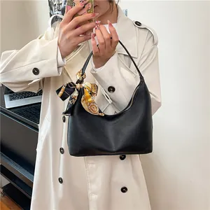 Black pebbled leather hobo bag with decorative silk scarf and metal zipper detail
