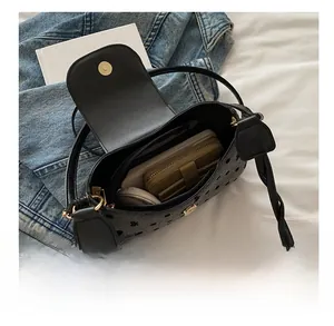 Internal view of black polka dot crossbody bag showing spacious capacity for phone and wallet