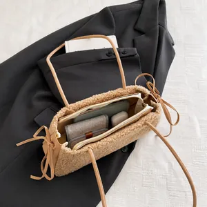 Interior view showing the large capacity of the beige faux fur mini tote bag