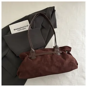 Detailed view of deep brown matte suede tote bag with elegant pleated design and leather strap