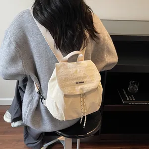 Minimalist beige nylon backpack with drawstring closure and striped straps for women