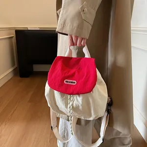 Contrast red and beige nylon backpack with drawstring and You Ji Bear logo patch