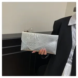 Silver envelope clutch bag with crocodile texture pattern and metallic chain strap detail