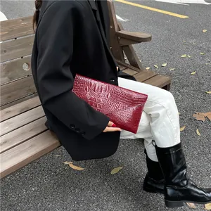 Fashionable burgundy crocodile pattern chain crossbody envelope bag for women on model