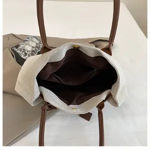 Top view of cream woven canvas tote bag showing interior space with zipper pocket and magnetic snap