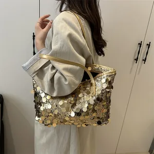 Stylish gold oversized sequin tote bag with metallic sheen and leather handles