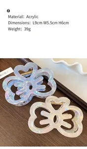 Detail view of acrylic butterfly hair claw clips in iridescent cream and purple shades