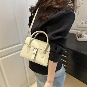 Minimalist off-white leather crossbody bag with retro buckle and top handle for women
