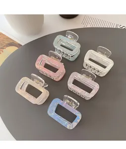 Set of six colorful rectangular hair claw clips with a pearlescent finish on a grey display