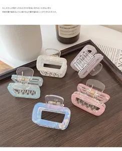 Detailed macro view of high-quality acetate hair claw clips in assorted pastel shell colors