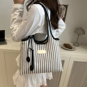 Minimalist striped canvas tote bag with black leather handles and large capacity