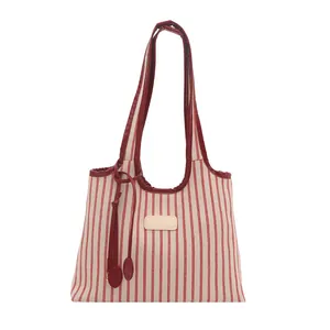 Minimalist red and white striped tote bag with red handles on a plain white background