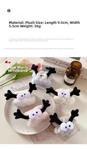 Detailed view of plush wristbands for washing face in pink, blue, white, and grey