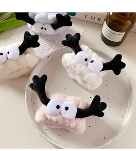 Detail of plush animal face wristbands showing soft texture and cute 3D elk antler design