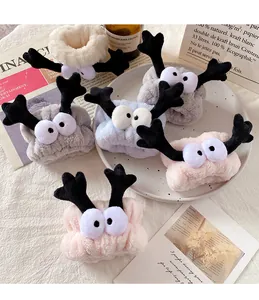 Detailed view of high-density coral fleece headbands with cute reindeer eyes and horns