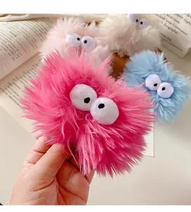 Close-up of soft plush headband with cute big eyes design in four vibrant colors