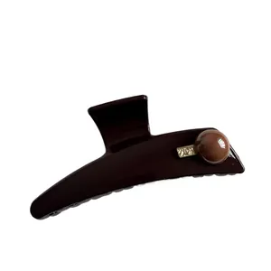 Elegant dark brown hair claw clip with glossy finish and gold metallic bead accent