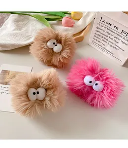 Detailed view of plush pink and brown wristbands with cute eye decorations for washing