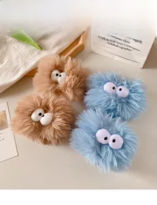 Close-up of fuzzy plush wristbands and headbands with cute cartoon big eyes decoration