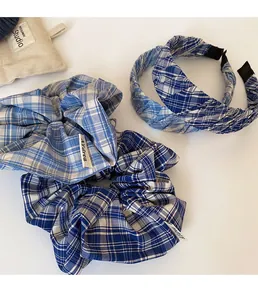 Detailed view of blue plaid fabric hair accessories set including headbands and scrunchies