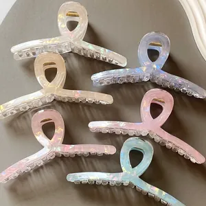 Set of six large iridescent cross-hollow hair claws in assorted pearlescent colors