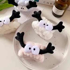 Cute plush headband and wristband set with cartoon eyes and reindeer antlers