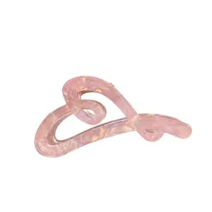 Pink translucent heart-shaped hair claw clip with marble texture and metal spring