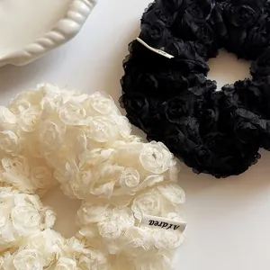 Exquisite 3D lace rose flower scrunchies in black and beige mesh fabric with Aydrea label
