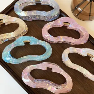 French vintage cloud-shaped hair claws in iridescent pastel colors on wooden tray