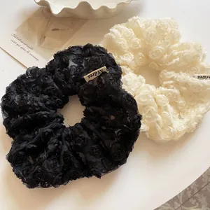 Set of two elegant lace scrunchies in black and white with 3D rose flower patterns