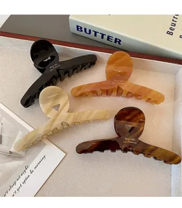 Detail of large acetate hair claws in leopard, tortoiseshell and marble patterns