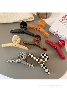 Detailed collection of large acetate hair claws in leopard, tortoiseshell and checkered patterns