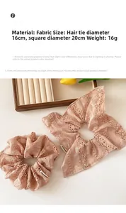 Detailed view of pink lace scrunchies with floral embroidery and scalloped edge details