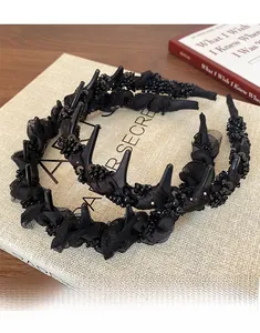 Detail of black lace bubble headband with non-slip shark teeth comb and beaded mesh texture