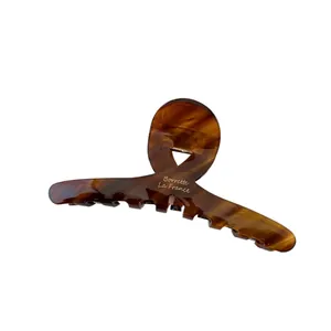 Large amber leopard print acetate claw clip with gold lettering for hair styling