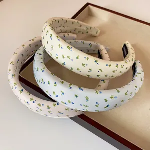 Floral padded sponge headbands set with blue and green flower patterns on a tray