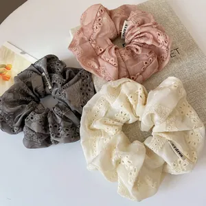 Three-piece set of solid color lace scrunchies in pink, grey and white organza fabric