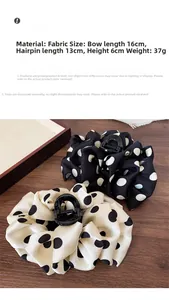 Detail of French large polka dot satin bow hair claw with size and material labels
