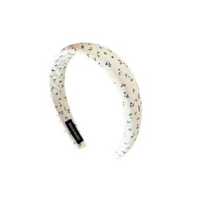Floral sponge headband with blue flowers on white fabric for volume hair styling