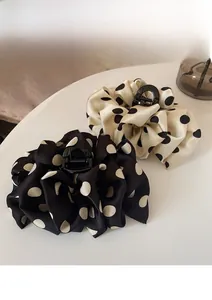 Close-up of French polka dot bubble hair claws in satin fabric with pleated texture