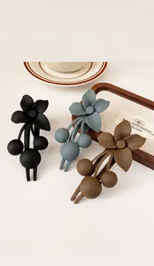 Detailed view of matte flower and cherry hair clips with dimensions and plastic material