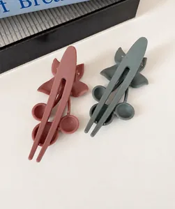 Close-up of matte Morandi flower duckbill hair clips in dusty pink and grey blue colors