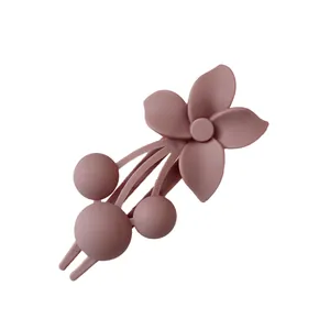 Morandi dusty rose flower hair clip with a minimalist matte finish on white background