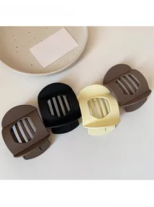 Set of four matte hair clips in earthy tones including black, coffee, cream, and tan