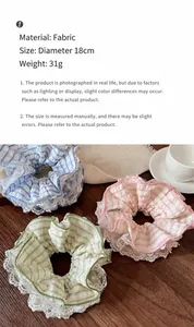 Close-up of pastel plaid scrunchies with lace trim on a rustic wooden surface