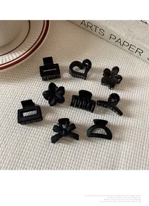 Lot détaillé de neuf pinces à cheveux noir mat avec nœuds et motifs variés